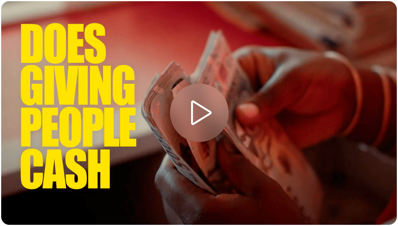 A GiveDirectly recipient counting cash