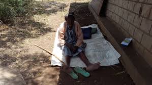 woman sitting on ground next to cane