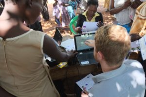 Country Director Joe Huston verifies recipient using biometrics