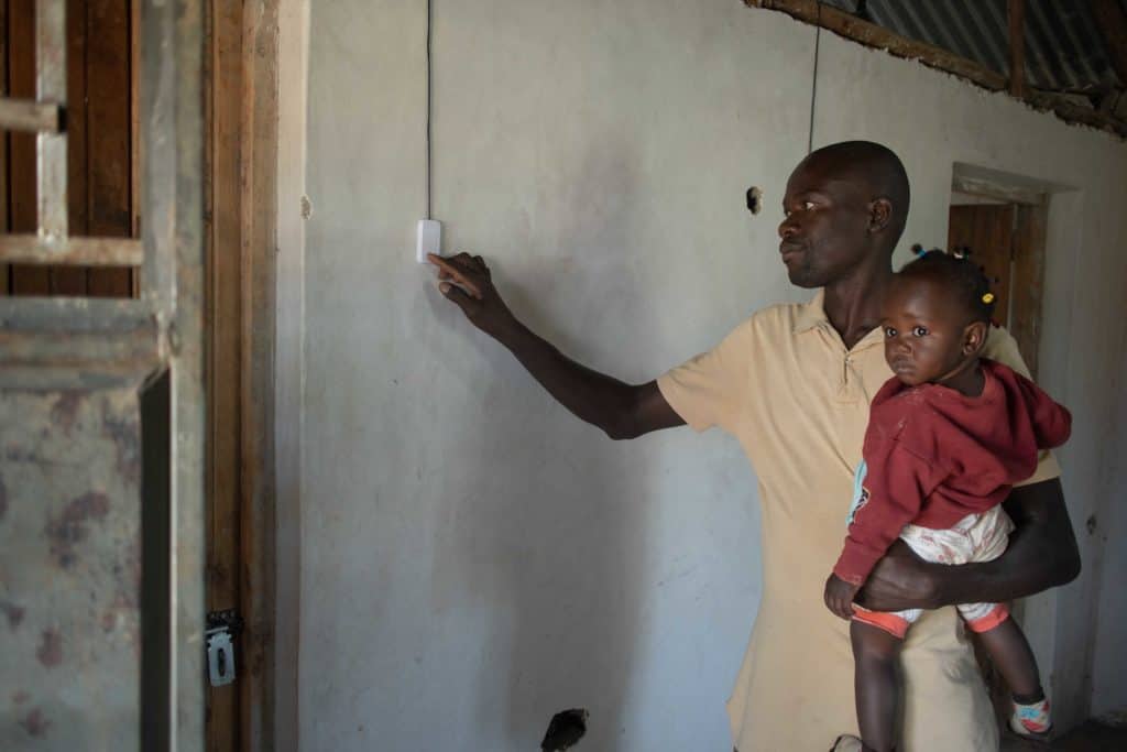 Frederick with his daughter turning on a lightswitch