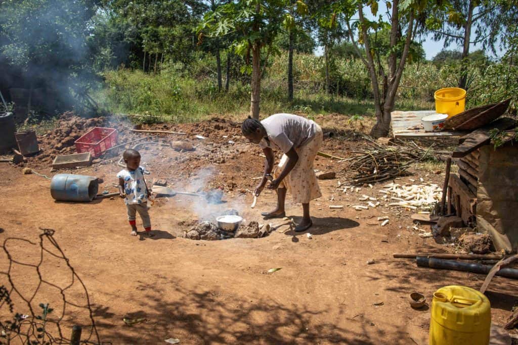 Joyce cooking outside her home