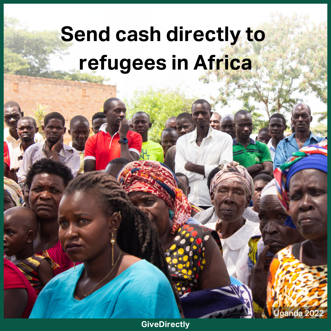 Header image of a group of 30 or so refugees in Uganda sitting together at a GiveDirectly registration event in 2022. They look as if they are listening intently to a speaker just off to the left side of frame.